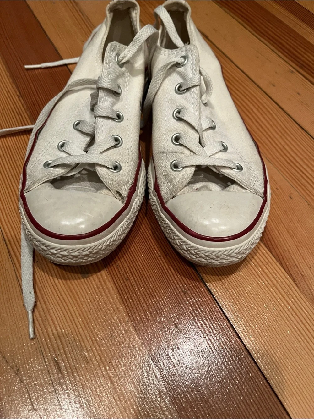 Converse low-top canvas sneakers in white with red trim